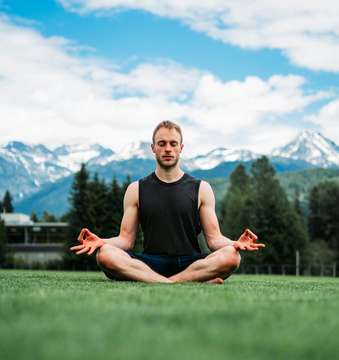 Participants engaged in meditation surrounded by stunning Himalayan scenery